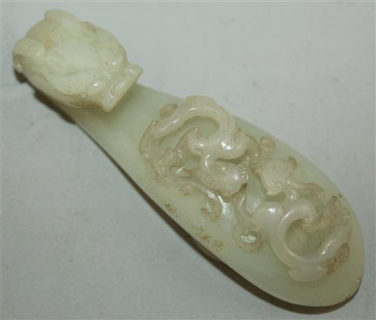 A Chinese white jade dragon belt hook, 18th century, 10cm, slight losses to chi-dragons, later piercings